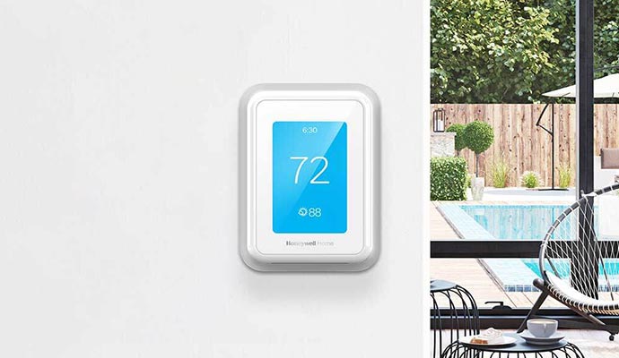 A smart thermostat shows temperature in the home