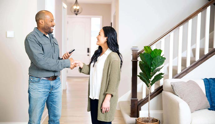 Happy customer shaking hand with a professional from Honeywell Home