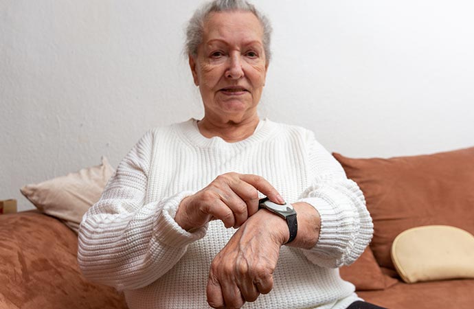 An elderly person using medical alert device