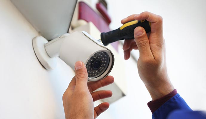 a professional installing a security camera